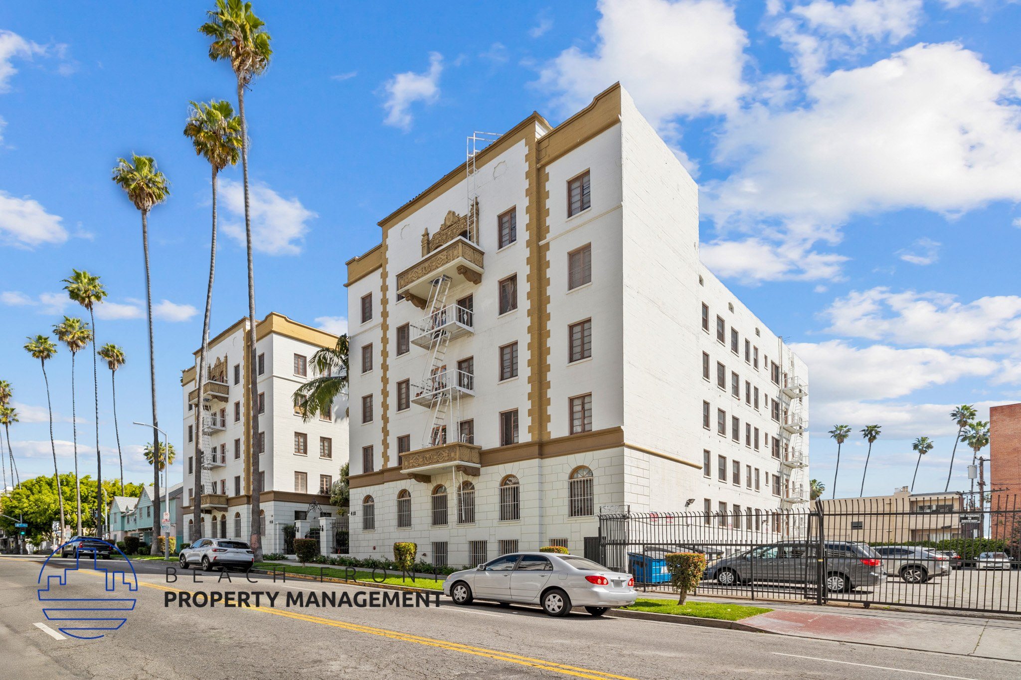 A white building with a sign that says Property Management on the bottom left.